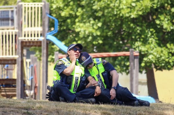 Devastated police officers at the primary school in Devonport which was the scene of a fatal jumping castle accident.