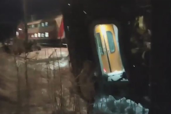 Train carriages lie at the scene of a bridge collapse in Russia.