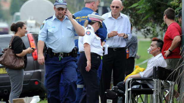 Roger Dean, seated, is given oxygen after a fire engulfed the nursing home.