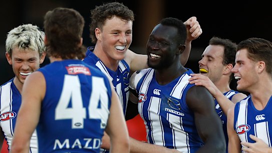 Majak Daw is mobbed by teammates.