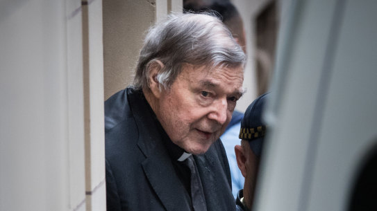 George Pell leaving Melbourne's Supreme Court building in handcuffs in August.