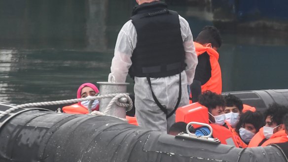 Migrants arrive in port in Dover after crossing the English Channel from France.