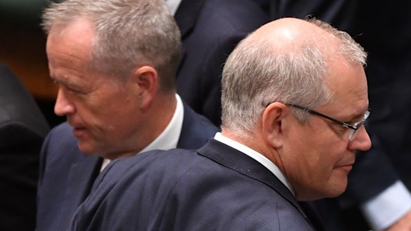 Prime Minister Scott Morrison (right) crosses paths with Opposition Leader Bill Shorten at Parliament House.