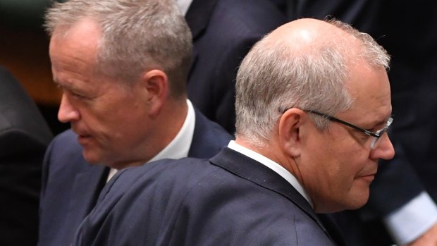 Prime Minister Scott Morrison (right) crosses paths with Opposition Leader Bill Shorten at Parliament House.
