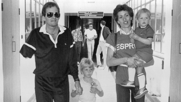 Jack Newton leaving hospital with his wife and children.