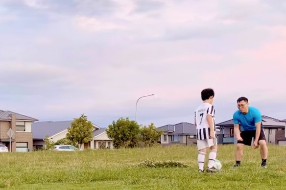 Kwang Kyung Yoo playing soccer with a child in 2022.