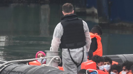Migrants arrive in port in Dover after crossing the English Channel from France.