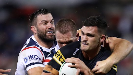 Panthers halfback Nathan Cleary is wrapped up by the Roosters’ James Tedesco.