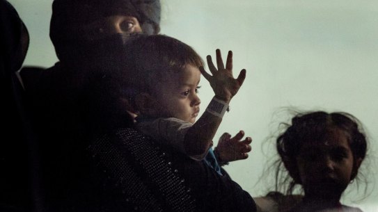Families evacuated from Kabul, Afghanistan, sit onboard a bus after they arrived at Washington Dulles International Airport, in Chantilly, Va., on Tuesday, Aug. 31, 2021. (AP Photo/Gemunu Amarasinghe)