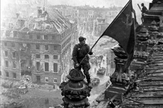 Soviet soldiers hoisting the red flag over the Reichstag in Berlin in May 1945