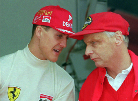 Ferrari consultant Niki Lauda chats with defending champion Michael Schumacher of Germany, left, during the practice session for the Monaco F1 Grand Prix , May, 1996.