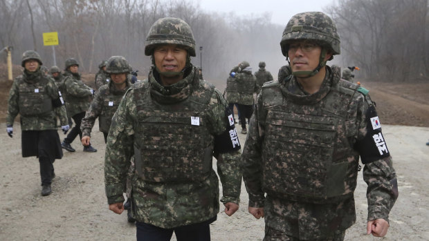 South Korean Gangwon Province Governor Choi Moon-soon, centre left, is escorted by South Korean army soldiers as he visits the DMZ this week.