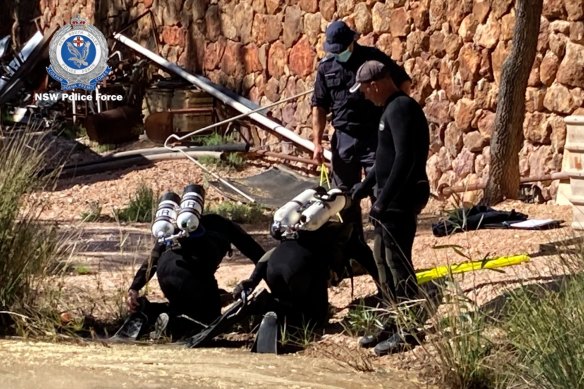 Police divers search the property. 