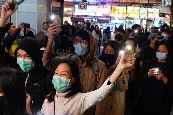 People raise their cellphones lights as they form a human chain on New Year's eve in Hong Kong.