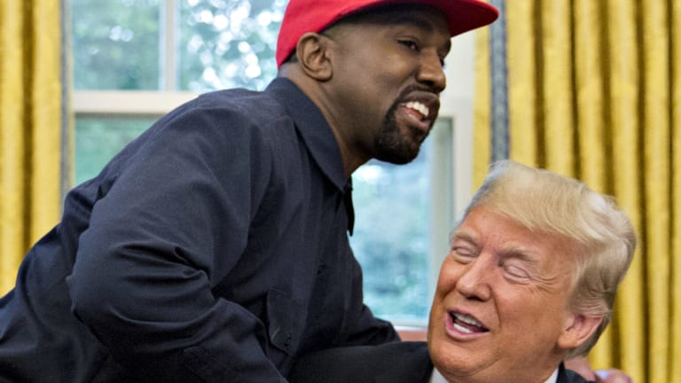 Rapper Kanye West shakes hands with US President Donald Trump during a meeting in the Oval Office.