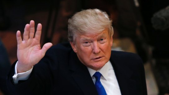 U.S. President Donald Trump waves as he arrives during the annual meeting of the World Economic Forum in Davos, Switzerland, Thursday, Jan. 25, 2018. (AP Photo/Michael Probst)