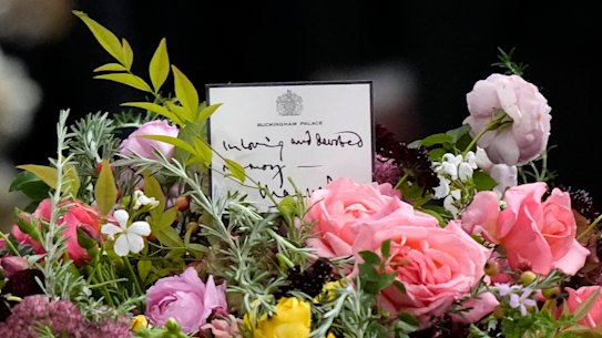 The crown, flowers and handwritten note from King Charles on the Queen’s coffin.
