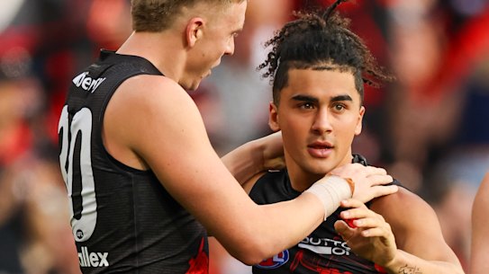 Isaac Kako celebrates a goal with Nate Caddy on Anzac Day.