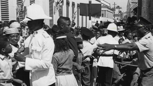 Police attempted to control the crowd as they struggled to get a closer look at Britain's Queen Elizabeth and Prince Philip on their arrival in Trafalgar Square, Bridgetown in Barbados in 1966.