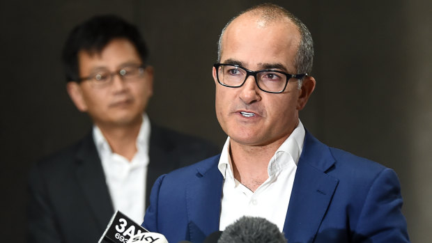 Acting Premier James Merlino announces the new date for hotel quarantine to restart. Behind him is Deputy Chief Health Officer Allen Cheng.