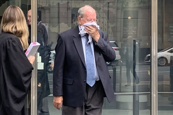 Christian Brother Rex Francis Elmer tried to hide his face after pleading guilty in the County Court in Melbourne on Monday.