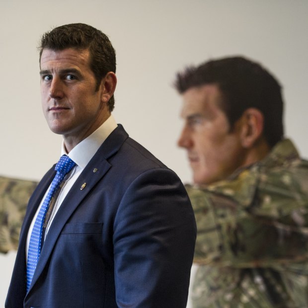Ben Roberts-Smith pictured in front of a portrait.