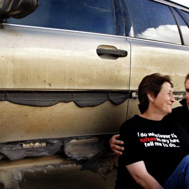 Kinglake residents Lois and Luke van den Berk leaning up against their singed car in Mill Park after the fires.