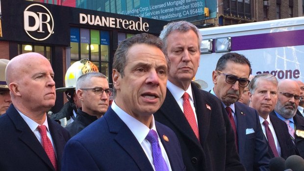 New York Governor Andrew Cuomo, left wearing a purple tie, and New York City Mayor Bill de Blasio, right, originally applauded Amazon's decision to open a new headquarters in Queens.