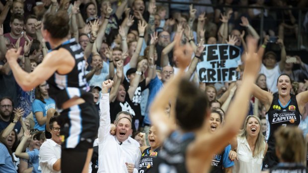 Canberra Capitals coaches and players cheer as they realise their dream of winning the championship.
