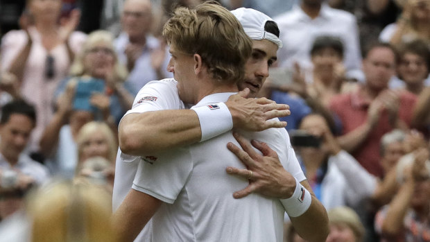 South Africa's Kevin Anderson hugs John Isner of the United States, right, after the longest Wimbledon semi-final in history.