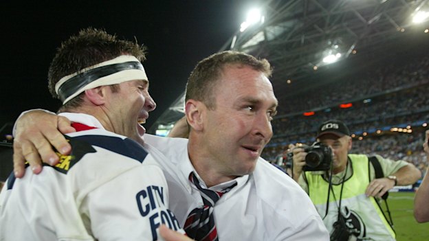 Ricky Stuart celebrates with Brad Fittler after winning a title in his first season as a coach with the Roosters in 2002.