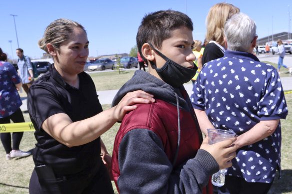 Adela Rodriguez with her son, Yandel Rodriguez, 12, after they were evacuated following a shooting at the nearby Rigby Middle School on Thursday.