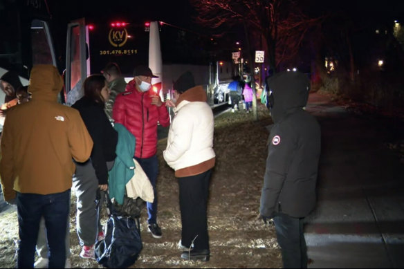 Migrant families as they get on to a bus to transport them from near the vice president’s residence to an area church after they arrived in Washington, DC.