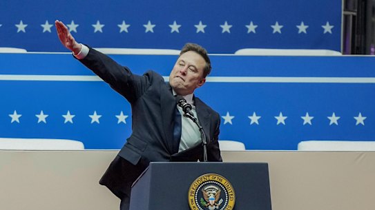 Elon Musk gestures as he speaks during the inaugural parade inside Capitol One Arena following President Donald Trump’s inauguration.