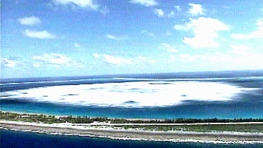 The sea close to the shore of Fangataufa Atoll turns white following the detonation of an underground French nuclear test.