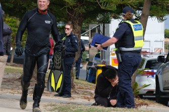 Police and family at the beach on Sunday. 