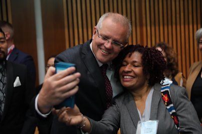 PNG-based Caritas aid worker Diane Unagi with Prime Minister Scott Morrison in December 2019.