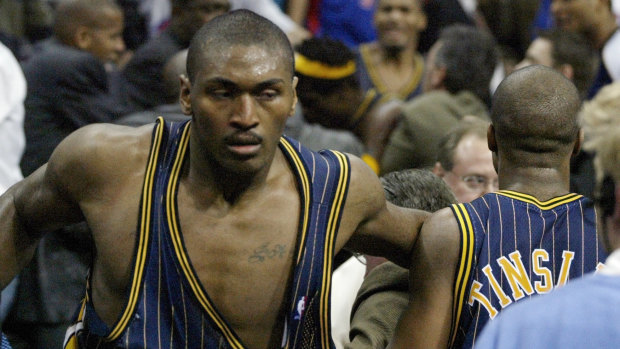 Indiana forward Ron Artest returns to the court after charging into the crowd.