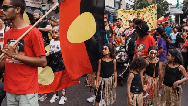 Protesters march through Redfern on Australia Day to protest celebrating on January 26.