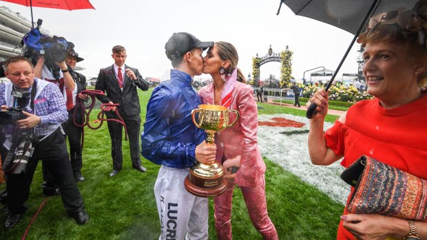 'It's unreal': Kerrin McEvoy celebrates with the Melbourne Cup and a kiss from wife Cathy.