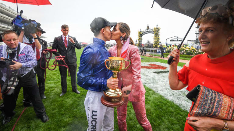 'It's unreal': Kerrin McEvoy celebrates with the Melbourne Cup and a kiss from wife Cathy.