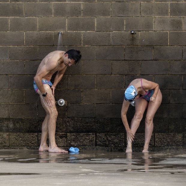 Port Melbourne Icebergers shower after swimming in the bay, which has had poor water quality.