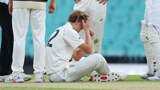 All-rounder Cameron Green goes down after being struck in the head while bowling at the SCG.