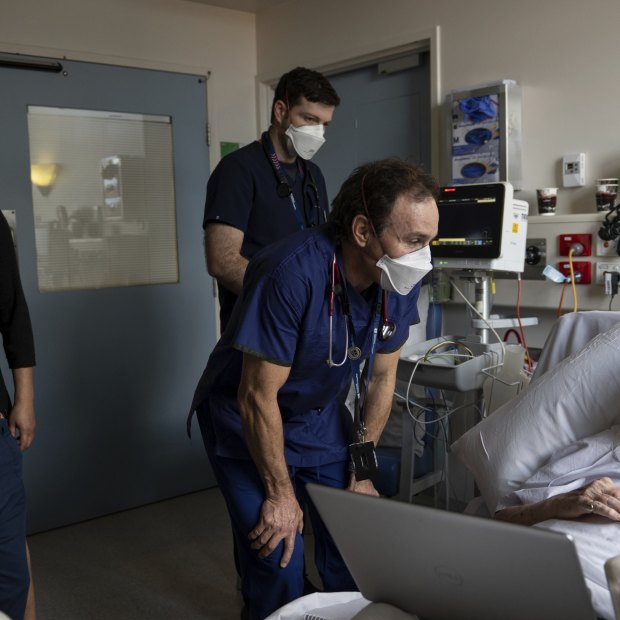 Associate Professor Doug Johnson, the head of general medicine, speaks to patient Nicholas Leray-Meyer during ward rounds.