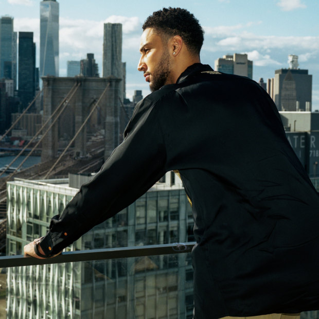 Simmons on the balcony of his new eight-bedroom apartment in Brooklyn. 