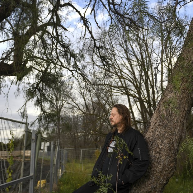 William Gwynne leans on a tree in what was once his backyard in Northcote, on the banks of the Merri Creek.