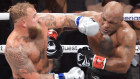 Boxer Jake Paul receives a punch from Mike Tyson during their heavyweight bout at AT&T Stadium in Arlington, Texas.