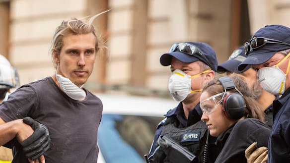 Activists from Extinction Rebellion are seen attached to a catamaran in the the middle of the Brisbane CBD, Thursday, October 10, 2019.