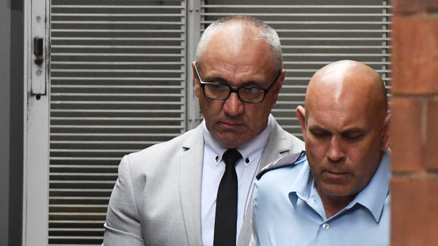 Michael Meakin (left) is taken from the NSW Supreme Court in Sydney on Friday.