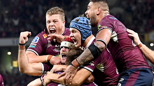 James O’Connor is swamped by teammates.